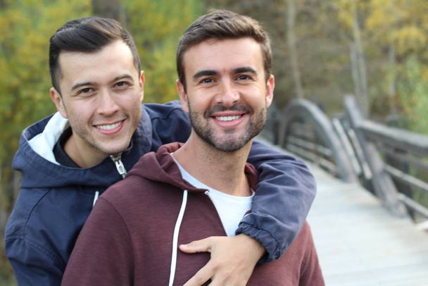 Gay couple enjoying the park in autumn - Фото, изображение