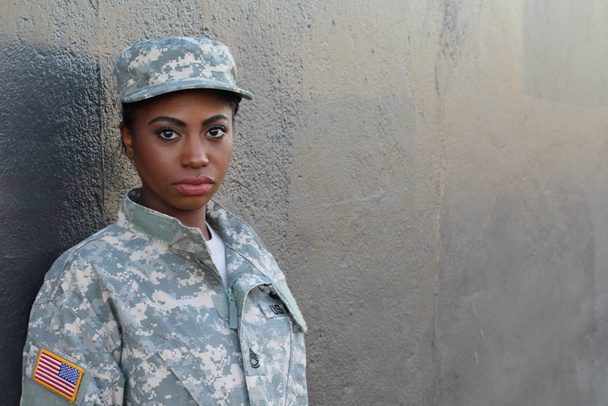 Female American Soldier on grey wall background  - Фото, изображение