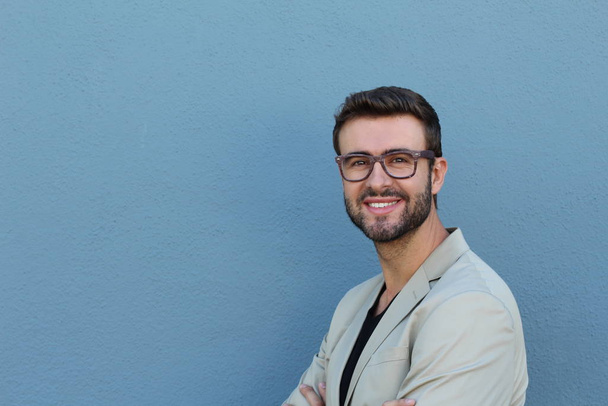 close-up portrait of handsome young bearded man in front of wall - Photo, Image
