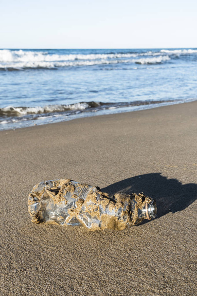 used plastic bottle on the sand of a beach - Photo, Image