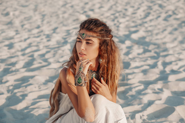 attractive bohemian style woman posing on the beach sand - Photo, image
