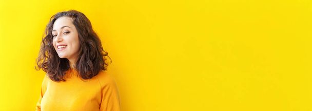 Happy girl smiling. Beauty portrait young happy positive laughing brunette woman on yellow background isolated. European woman. Positive human emotion facial expression body language Banner - Zdjęcie, obraz