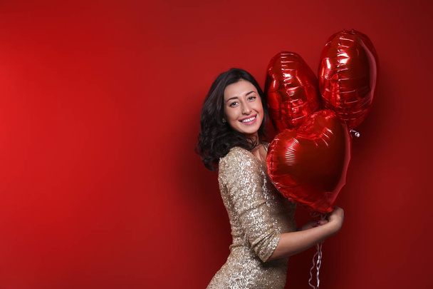 Beautiful female holding floating balloons for st. valentine's day holiday. - Foto, immagini