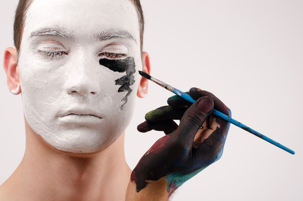 Beautiful young man painted on the face, preparing for Halloween - Foto, Imagem