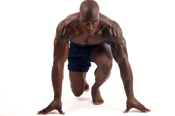 Black bodybuilder preparing for a training start, isolated on a white background - Foto, imagen