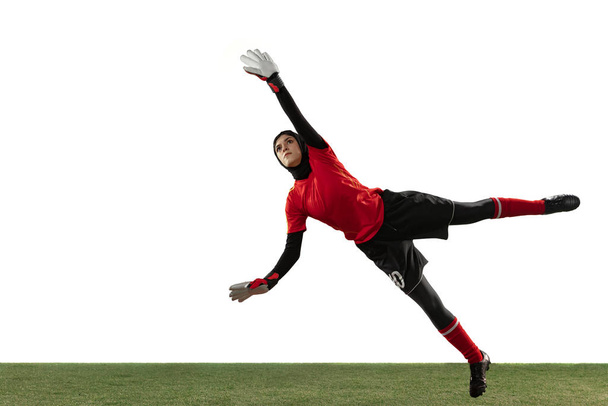 Arabian female soccer or football player, goalkeeper on white studio background - Foto, imagen