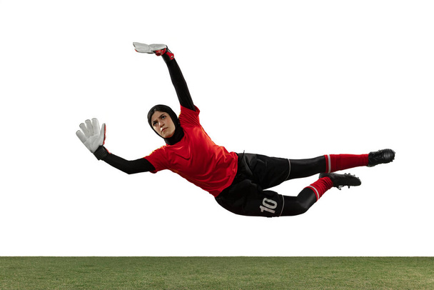 Arabian female soccer or football player, goalkeeper on white studio background - Foto, imagen