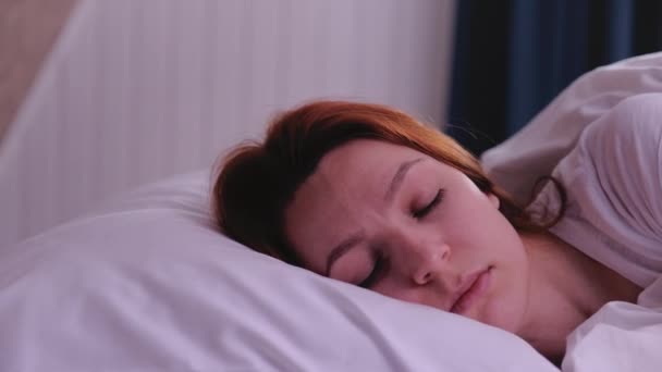 Beautiful young girl is sleeping on a white pillow. - Filmmaterial, Video