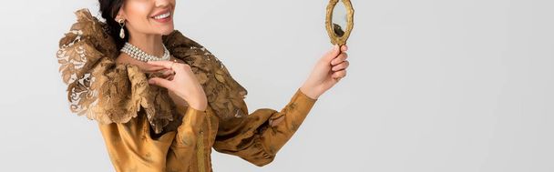 panoramic shot of queen holding mirror isolated on grey - 写真・画像