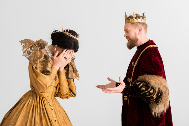 queen and king with crowns quarreling isolated on grey  - Fotoğraf, Görsel