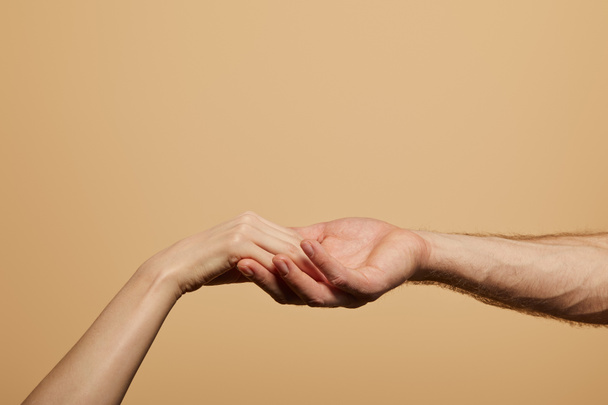 cropped view of man holding woman hand isolated on beige - Fotografie, Obrázek