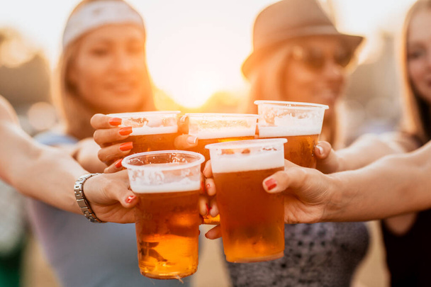 handsome young women with beer glasses celebrating start of the festival - Foto, Bild