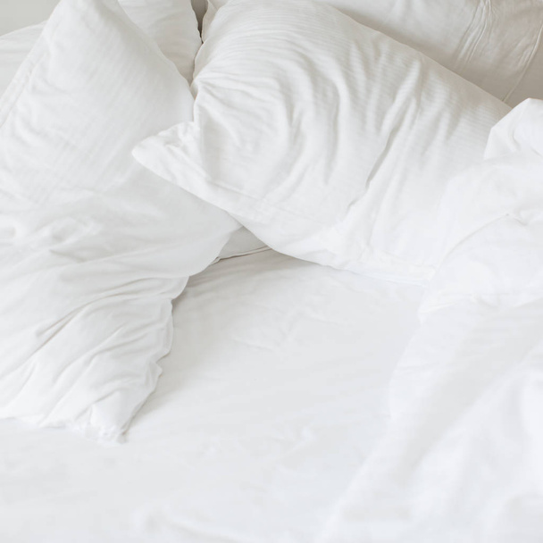 white soft bed with white pillows and blanket  - Valokuva, kuva