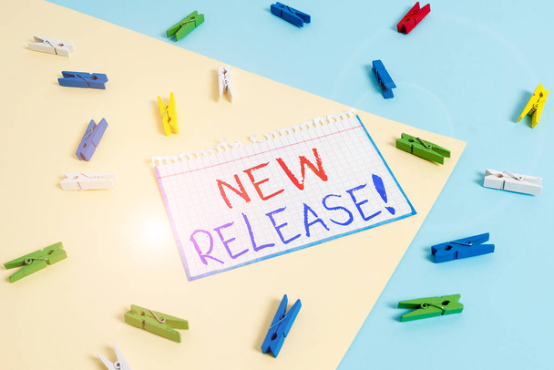 Writing note showing New Release. Business concept for announcing something newsworthy recent product Colored clothespin paper reminder with yellow blue background - Photo, Image