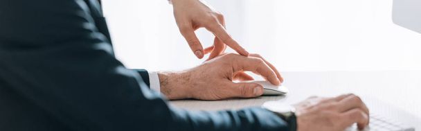 panoramic shot of secretary touching hand of businessman in office  - Fotoğraf, Görsel