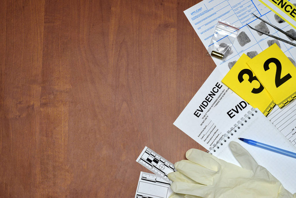 Documenti durante il processo di indagine sulla scena del crimine in laboratorio. Etichette con impronte digitali e guanti di gomma sul tavolo vuoti
 - Foto, immagini