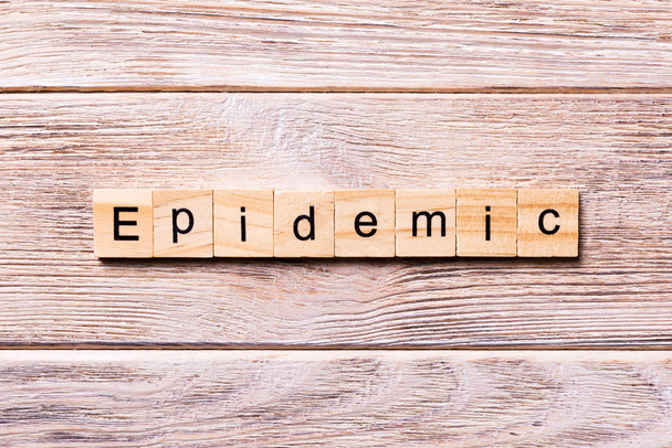 epidemic word written on wood block. epidemic text on wooden table for your desing, coronavirus concept top view - Photo, Image