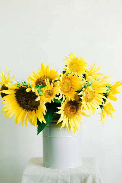 bouquet of bright yellow sunflower flowers in a retro vase on a white background - Photo, Image