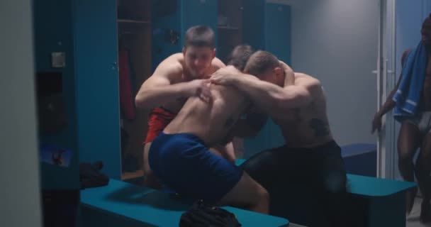Men celebrating in locker room - Footage, Video