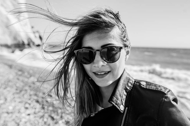 beautiful girl in the sunglasses on the beach - Фото, изображение