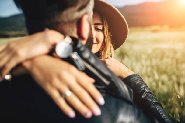 Young couple in leather jackets in the field - Foto, imagen