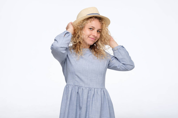 Cute young caucasian lady in blue dress with hat on summer vacation - Photo, Image