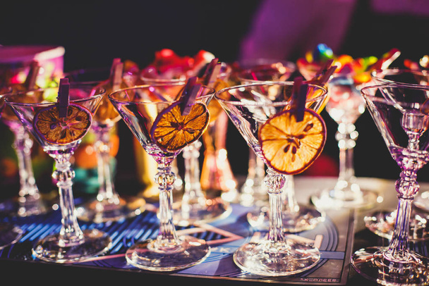 View of alcohol setting on catering banquet table, row line of different colored alcohol cocktails on a party, martini, vodka, and others on decorated catering bouquet table event  - Foto, Imagem