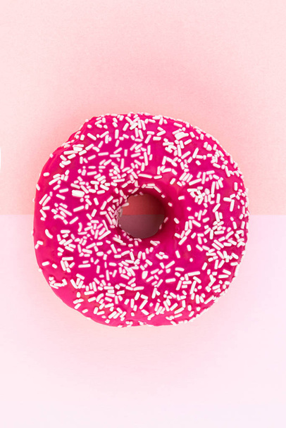 Pink donut with icing on pastel pink background - Photo, Image
