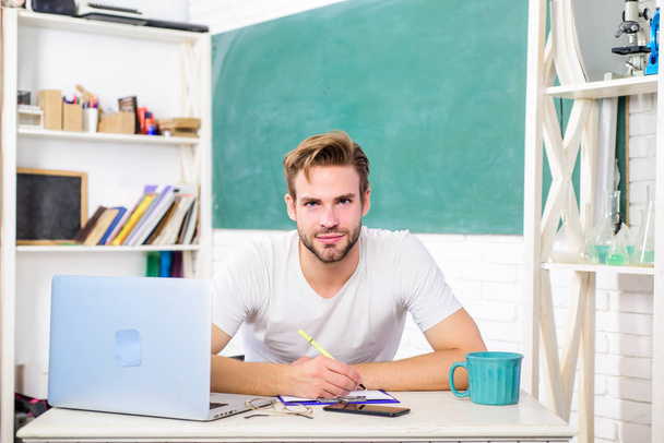 online college life. school teacher use laptop and smartphone. modern education concept. back to school. Working day morning. man make note and drink coffee. student man in classroom with tea cup - Photo, Image