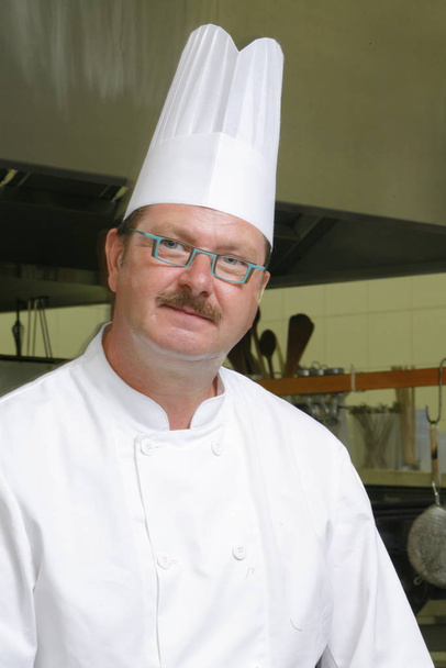 chef in uniform cooking in the kitchen - Valokuva, kuva