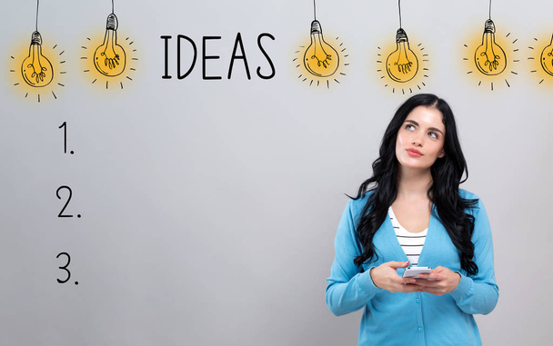Idea list with woman holding a smartphone - Photo, image