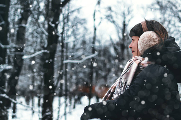 Woman portrait in snowing weather. Girl in the park at winter time. Winter female portrait. - Photo, Image