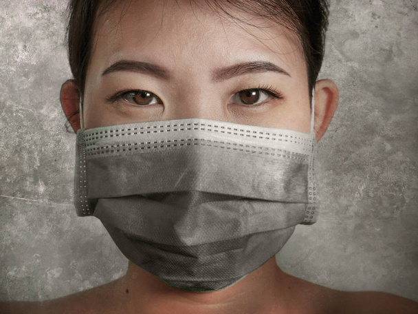 young beautiful Asian Chinese woman in protective face mask in prevention against Wuhan Coronavirus epidemic outbreak in China in virus transmission and infection concept  - Fotó, kép