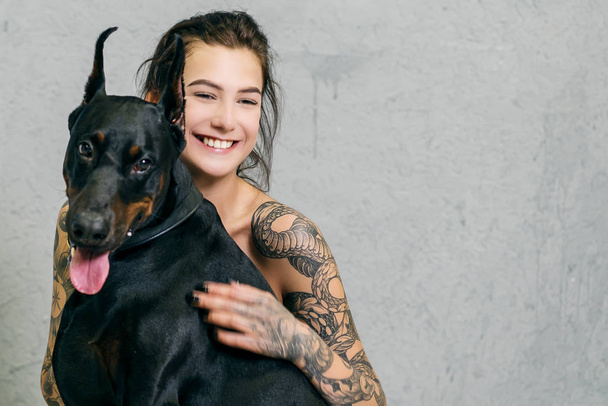 portrait of a girl with a black dog - Photo, Image