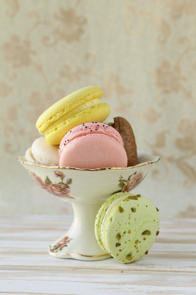 French multicolored macaroons on a vintage background - 写真・画像