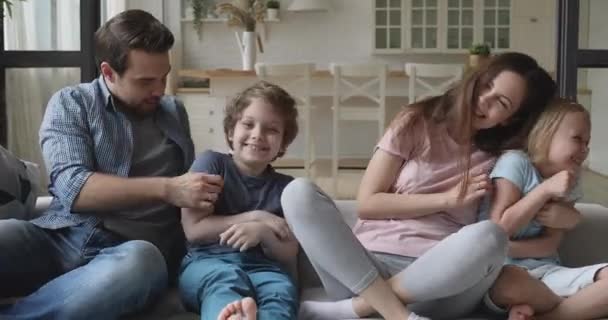 Overjoyed young family couple playing with happy son and daughter. - Footage, Video