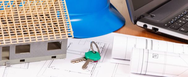 Home keys, small house, electrical diagrams with laptop for engineer állások, building home - Fotó, kép