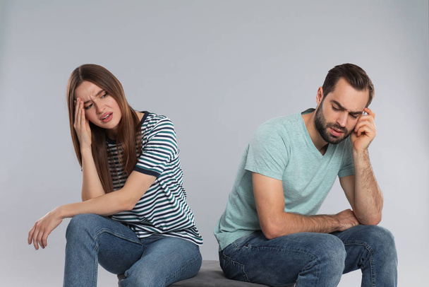 Couple with relationship problems on light grey background - Foto, Imagem