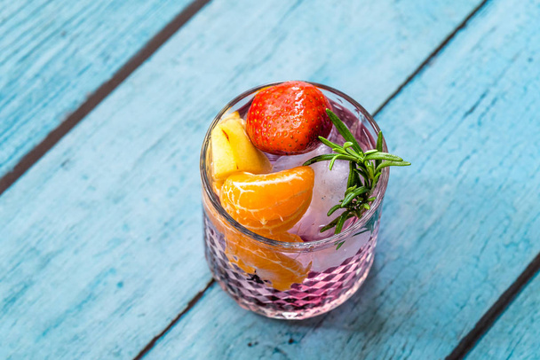 Fruit Cocktail with Strawberry, Mandarin, Apple and Rosemary / Fresh Pink Punch Beverage. Summer Drink. - Fotografie, Obrázek