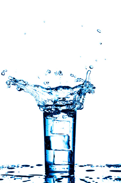 Water splashes in the glass on white background - Valokuva, kuva