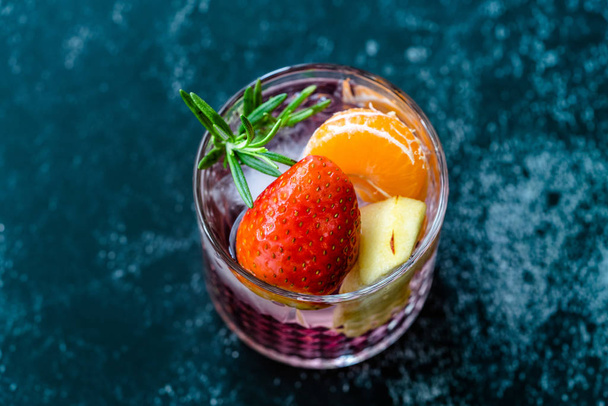 Fruit Cocktail with Strawberry, Mandarin, Apple and Rosemary / Fresh Pink Punch Beverage. Summer Drink. - Foto, imagen