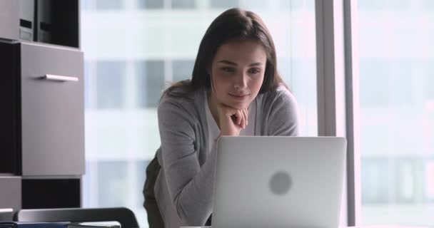 Pleasant millennial businesswoman typing response to client. - Felvétel, videó