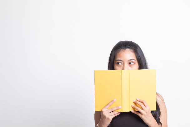 Young Asian woman with a book cover her face. - Foto, Bild