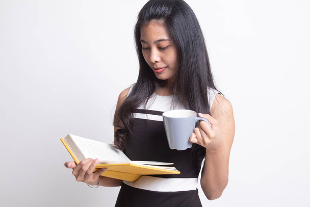 Young Asian woman with a book and cup of coffee. - Photo, Image