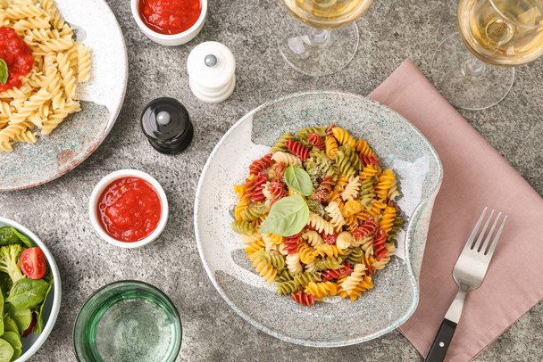 Flat lay composition with tasty pasta on grey table - Zdjęcie, obraz