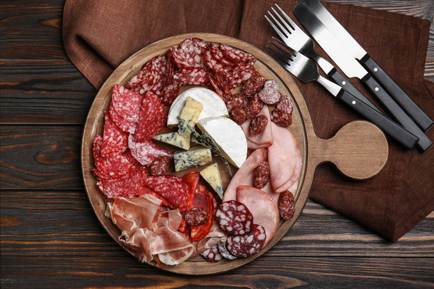 Tasty ham and other delicacies served on wooden table, flat lay - Photo, Image