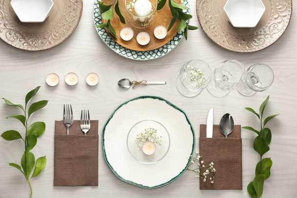 Elegant table setting with green plants on white wooden backgrou - Fotó, kép