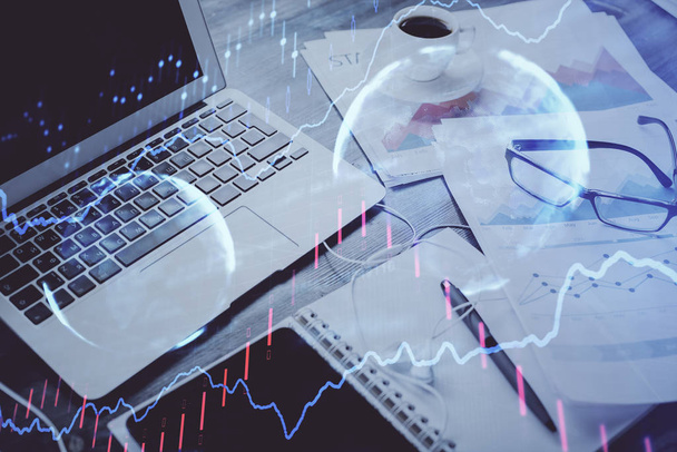 Stock market graph on background with desk and personal computer. Double exposure. Concept of financial analysis. - Photo, Image