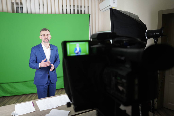 Een blogger neemt een video op met een groene achtergrond. De camco - Foto, afbeelding
