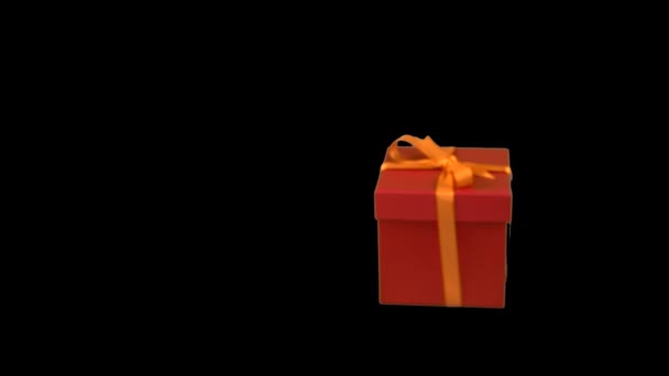 red gift box with yellow gold ribbon bow dolly in track in zoom in at transparent background alpha channel chroma key transparent background have empty space for text soft focus lr pan - Video, Çekim